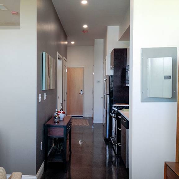 a long hallway with a door at the end.